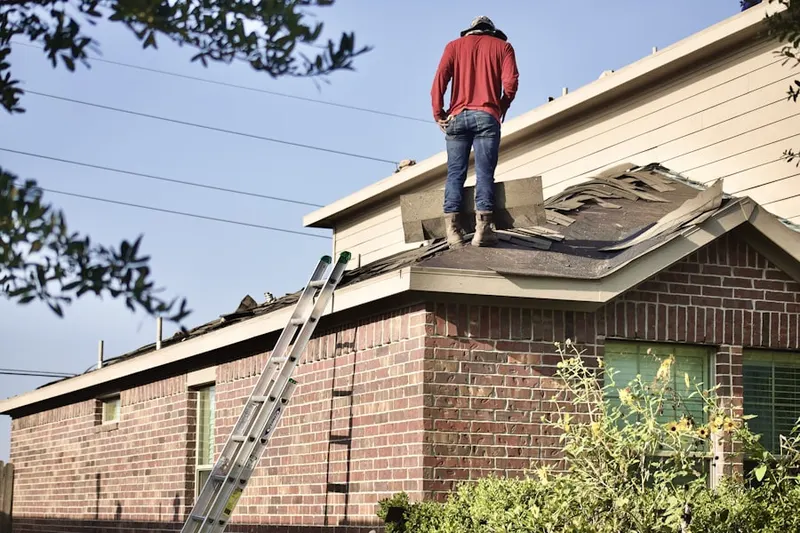 Professional roofer working on a residential roof in The Courts of Four Seasons
